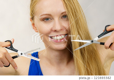Girl with scissors for haircutting Girl with scissors for haircutting 121693382