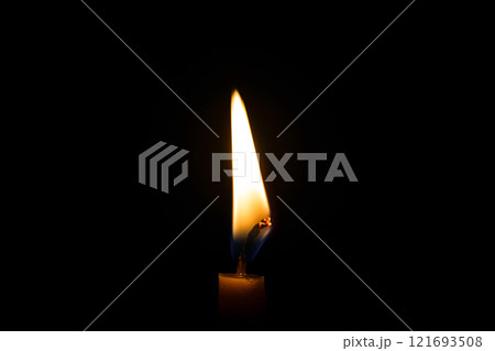 burning candle on black background 121693508