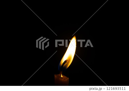 burning candle on black background burning candle on black background 121693511