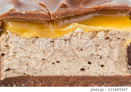 Chocolate bar in a cut. Slices of chocolate. Nougat and caramel. 121693567