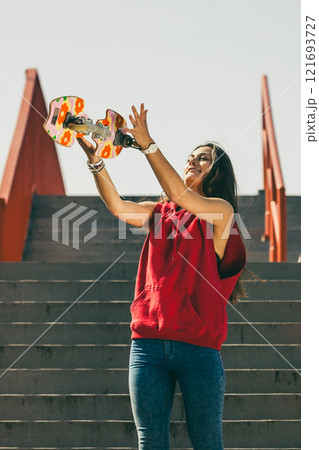 Urban skate girl with skateboard. 121693727