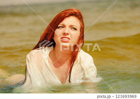 Redhaired happy girl on beach. Redhaired happy girl on beach. 121693969
