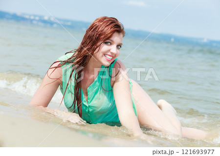 Redhaired happy girl on beach. Redhaired happy girl on beach. 121693977