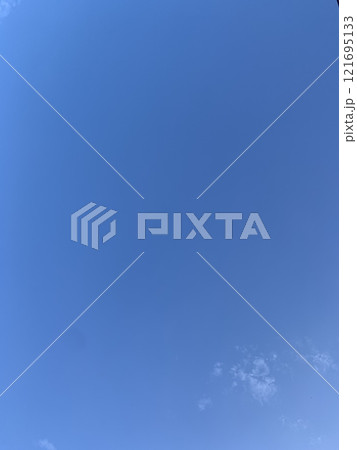 Bright blue sky with fluffy white clouds and sunlight 121695133
