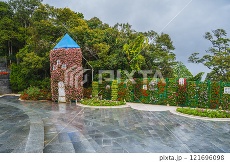 Picturesque view of the tower covered with live flowering plants Picturesque view of the tower covered with live flowering plants 121696098