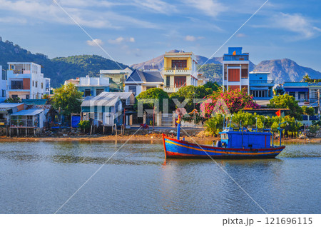 There are many traditional Vietnamese fishing boats and vessels in the bay on the river in Nha Trang There are many traditional Vietnamese fishing boats and vessels in the bay on the river in Nha Trang 121696115