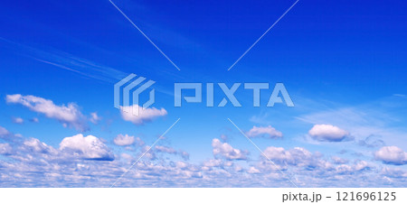background of blue sky with white fluffy cumulus clouds. Panorama of sky 121696125