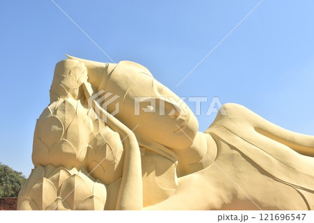 ancient reclining Buddha at Lokaya Sutha after renovate painting colors from white to yellow  121696547