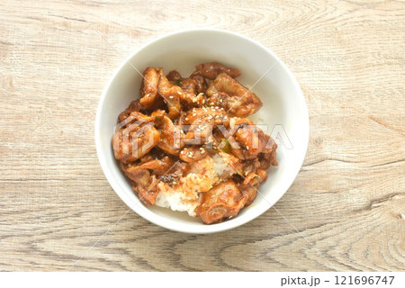 fried slice fermenting pork meat and mala sichuan sauce topping white sesame on plain rice in bowl 121696747