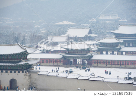 Snow falling in winter at Gyeongbokgung Palace and the sign says Gwanghwamun Gate, Seoul, South Korea. 121697539