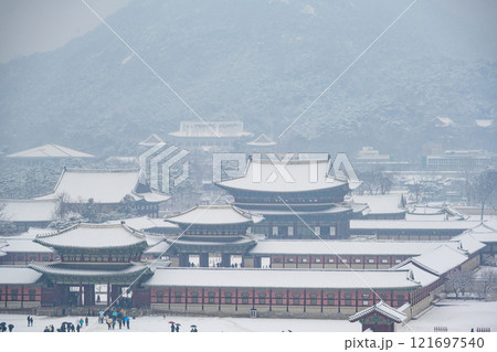 Snow falling in winter at Gyeongbokgung Palace and the sign says Gwanghwamun Gate, Seoul, South Korea. 121697540