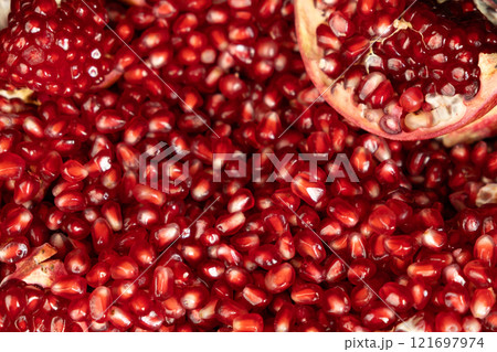 Pomegranate background, lots of peeled pomegranates and seeds Pomegranate background, lots of peeled pomegranates and seeds 121697974