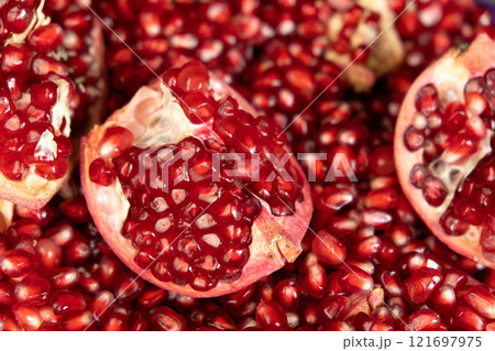 Pomegranate background, lots of peeled pomegranates and seeds 121697975