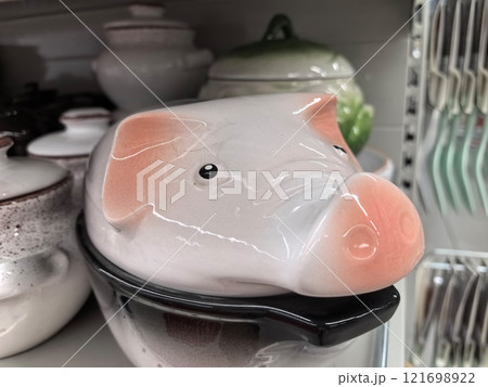 Unusual kitchen decor featuring a ceramic pig design for storage 121698922