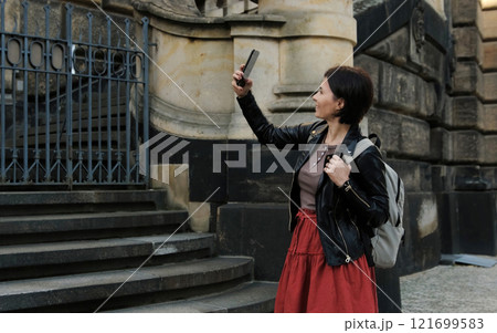Attractive Woman Strolls Through Touristic Places Of Dresden, Capturing Photos Of Sightseeings 121699583