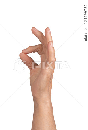 Pinch gesture. Elderly woman s wrinkled hand holding something tiny between thumb and forefinger, 121699780