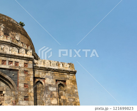 Ancient Indian building. Mughal stone architecture with decorative carvings, old dome. Historical Ancient Indian building. Mughal stone architecture with decorative carvings, old dome. Historical 121699823