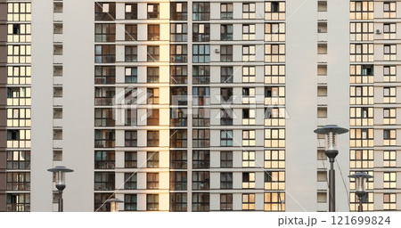 Urban building facade. Seamless pattern of a modern residential structure with rows of identical 121699824