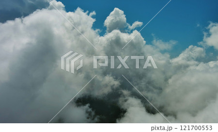 Flying through white fluffy clouds 121700553