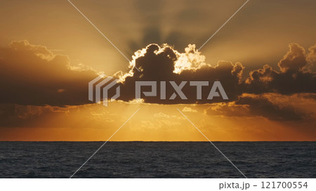 Sunrise over sea with illuminating clouds 121700554