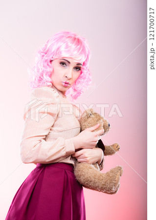childlike woman with teddy bear toy childlike woman with teddy bear toy 121700717