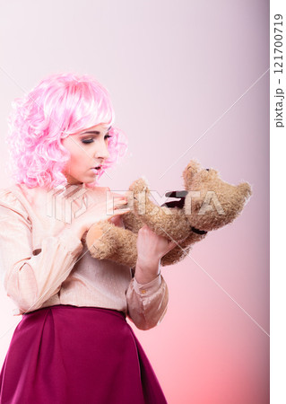 childlike woman with teddy bear toy childlike woman with teddy bear toy 121700719