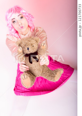 childlike woman with teddy bear toy childlike woman with teddy bear toy 121700733