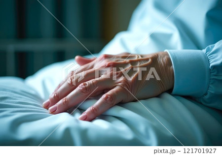 Close-up of Elderly Hand in Hospital Bed, representing aging, illness, and the struggle for recovery	 121701927