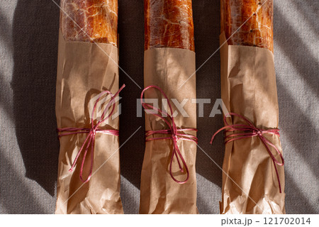 Traditional Hungarian Christmas cookies wrapped in craft paper, tied with ribbon on a gray textile background. Eco-friendly packaging. Zero waste Traditional Hungarian Christmas cookies wrapped in craft paper, tied with ribbon on a gray textile background. Eco-friendly packaging. Zero waste 121702014