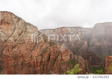 Towering Sandstone Cliffs in Zion National Park Shrouded by Clouds and Mist. 121702201