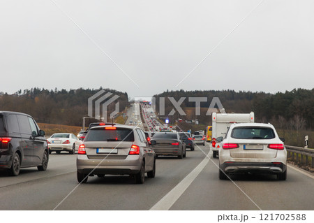 Back tail view of many cars stuck in row at highway road traffic jam cold overcast rainy winter day at Europe. Automobile accident vehicle rush hour collapse. Transportation vacation seasonal stuck Back tail view of many cars stuck in row at highway road traffic jam cold overcast rainy winter day at Europe. Automobile accident vehicle rush hour collapse. Transportation vacation seasonal stuck 121702588