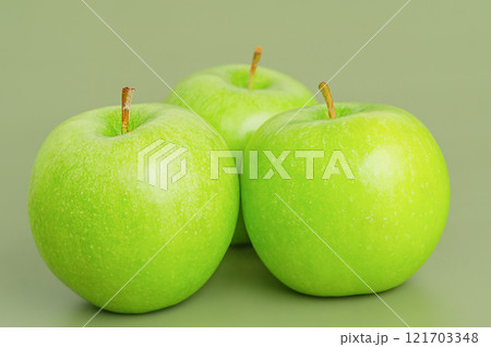 Three green apples. Apple fruit on a green background. Three green apples. Apple fruit on a green background. 121703348