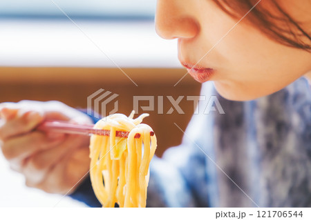 おいしいラーメンを食べてしあわせな若い女性 121706544