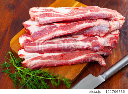 Raw meaty veal tenderloin on plate with fresh dill ready for cooking, closeup 121706786