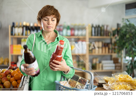 Adult woman choosing juices 121706853
