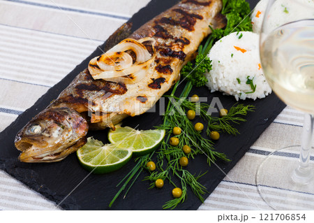 Baked trout with rice and white wine 121706854