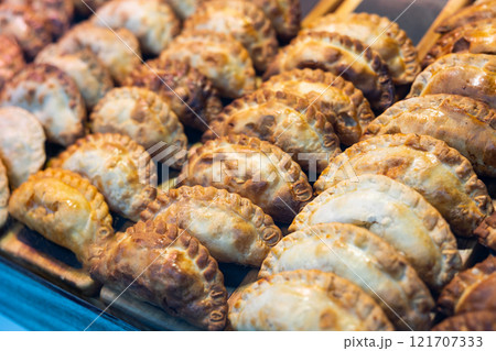Delicious empanadas lined up in rows in store window Delicious empanadas lined up in rows in store window 121707333