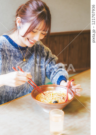 おいしいラーメンを食べてしあわせな若い女性 121707936