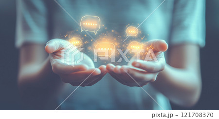 Two cupped hands offering glowing golden speech bubbles, symbolizing connection and communication in a creative and abstract concept Two cupped hands offering glowing golden speech bubbles, symbolizing connection and communication in a creative and abstract concept 121708370