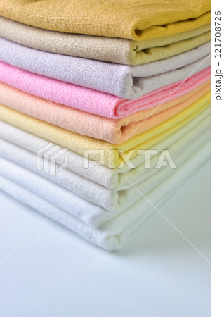 stack of colourful cotton clothes, pile of clothing on white background stack of colourful cotton clothes, pile of clothing on white background 121708726