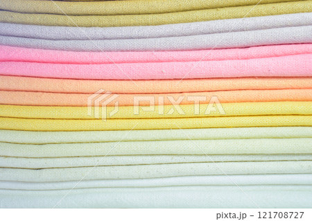 stack of colourful cotton clothes, close up pile of clothing 121708727