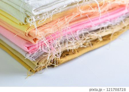 stack of colourful cotton clothes, pile of clothing on white background 121708728