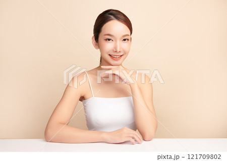 Beautiful young asian woman with clean fresh skin on beige background, Face care, Facial treatment, Cosmetology, beauty and spa, Asian women portrait. Beautiful young asian woman with clean fresh skin on beige background, Face care, Facial treatment, Cosmetology, beauty and spa, Asian women portrait. 121709802