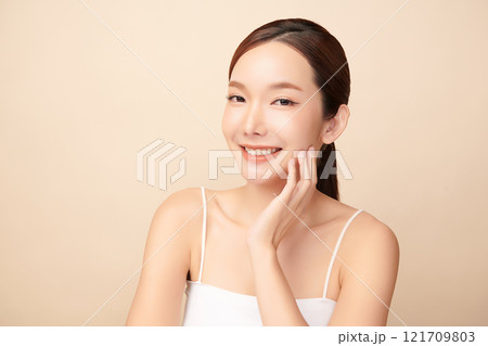 Beautiful young asian woman with clean fresh skin on beige background, Face care, Facial treatment, Cosmetology, beauty and spa, Asian women portrait. 121709803