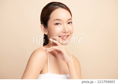 Beautiful young asian woman with clean fresh skin on beige background, Face care, Facial treatment, Cosmetology, beauty and spa, Asian women portrait. 121709805