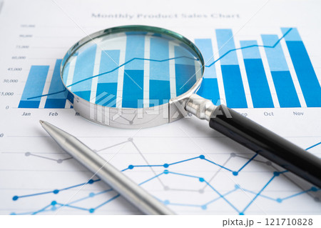 Magnifying glass on charts graphs paper. Financial development, Banking Account, Statistic, Investment Analytic research data economy. Magnifying glass on charts graphs paper. Financial development, Banking Account, Statistic, Investment Analytic research data economy. 121710828