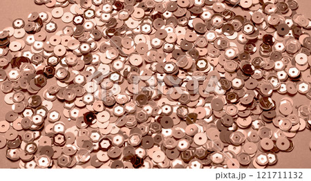 Shimmering pile of rose gold sequins for crafting and design 121711132
