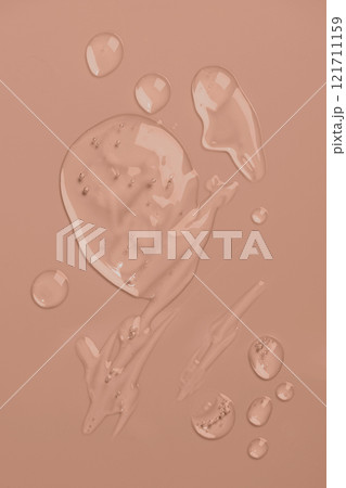 Transparent textured drops of gel-like liquid with bubbles on pastel beige background 121711159