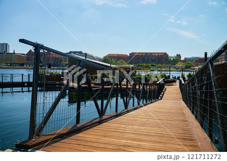 Wooden walkway leading to stylish restaurant on city embankment 121711272