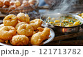 Diwali, Freshly fried puris being served alongside 121713782
